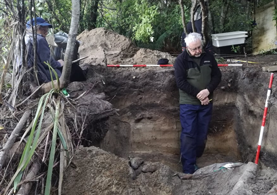 Brooke Tucker and Professor Atholl Anderson examine site stratigraphy during an excavation to salvage eroding archaeological material on Whenua Hou/Codfish Island. Photo: Johannes Fischer